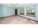 Spacious bedroom with two windows, neutral walls, carpet, ceiling fan and a small bookshelf at 5932 Whitebud Dr, Raleigh, NC 27609