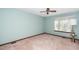 Clean and bright bedroom, with a ceiling fan and neutral carpet ready for your personal touch at 5932 Whitebud Dr, Raleigh, NC 27609