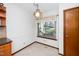 Bright breakfast nook with light-colored walls, a window with floral curtains, and an decorative hanging light fixture at 5932 Whitebud Dr, Raleigh, NC 27609