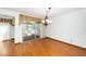 Cozy dining area with hardwood floors, a chandelier, and access to the screened in porch at 5932 Whitebud Dr, Raleigh, NC 27609