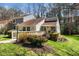 Charming home featuring a welcoming walkway and front porch, complemented by well-maintained landscaping and mature trees at 5932 Whitebud Dr, Raleigh, NC 27609