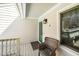 Inviting covered front porch with a wicker chair and a neutral colored exterior at 5932 Whitebud Dr, Raleigh, NC 27609