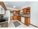Well-equipped kitchen with wood cabinets, granite countertops, and modern appliances, creating a convenient and stylish cooking area at 5932 Whitebud Dr, Raleigh, NC 27609