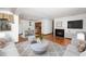 Bright living room with stylish furniture, a cozy fireplace, and an open layout that flows into the dining area at 5932 Whitebud Dr, Raleigh, NC 27609
