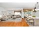 Open concept living room features hardwood floors, stylish furniture, a decorative rug, and a breakfast bar at 5932 Whitebud Dr, Raleigh, NC 27609