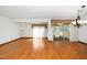 Spacious living room featuring hardwood floors, a large window, and access to sunroom at 5932 Whitebud Dr, Raleigh, NC 27609