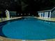 Large community pool with bathhouses, surrounded by lush greenery and trees at 5932 Whitebud Dr, Raleigh, NC 27609