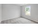 Light-filled bedroom with neutral carpet and a bright window at 65 Crow Field St, Roxboro, NC 27574
