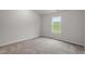 Bright bedroom with plush carpeting and a window view of the outdoors at 65 Crow Field St, Roxboro, NC 27574