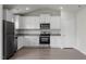 Bright kitchen features white cabinets, stainless steel appliances, granite counters and wood-look floors at 65 Crow Field St, Roxboro, NC 27574