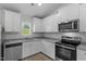 Modern kitchen with granite countertops, stainless steel appliances and white cabinets at 65 Crow Field St, Roxboro, NC 27574