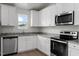 Modern kitchen with granite countertops, stainless steel appliances and white cabinets at 65 Crow Field St, Roxboro, NC 27574