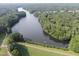 Stunning aerial view of the neighborhood lake surrounded by lush green trees at 6926 Leesville Rd, Raleigh, NC 27613