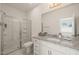 Bathroom featuring a glass-enclosed shower and granite countertops at 6926 Leesville Rd, Raleigh, NC 27613