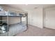 Second view of bunk bedroom with three windows and neutral carpeting at 6926 Leesville Rd, Raleigh, NC 27613