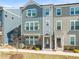 Charming townhome showcasing a well-manicured lawn and inviting covered entrance at 6926 Leesville Rd, Raleigh, NC 27613