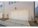 Attached single-car garage featuring neutral siding and a smooth, level driveway at 6926 Leesville Rd, Raleigh, NC 27613