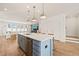 Open-concept kitchen featuring a center island that transitions to the living room at 6926 Leesville Rd, Raleigh, NC 27613