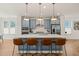 Bright kitchen with a center island featuring seating and stainless steel appliances at 6926 Leesville Rd, Raleigh, NC 27613