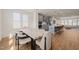 Open-concept kitchen featuring blue cabinets, stainless steel appliances, a kitchen island, and an open layout to the living room at 6926 Leesville Rd, Raleigh, NC 27613