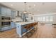 Open-concept kitchen and living space featuring pendant lighting at 6926 Leesville Rd, Raleigh, NC 27613