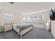 Bright main bedroom with soft carpet, a serene aesthetic, a TV, and plenty of natural light at 6926 Leesville Rd, Raleigh, NC 27613