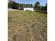 Spacious backyard with wooden fence, offering privacy and a perfect outdoor area for various activities at 6932 Buckhorn Duncan Rd, Holly Springs, NC 27540