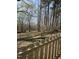 Backyard featuring a wooded area with mature trees and a wooden fence at 6932 Buckhorn Duncan Rd, Holly Springs, NC 27540