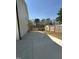 View of a fenced-in backyard with a concrete patio and the home's exterior wall at 6932 Buckhorn Duncan Rd, Holly Springs, NC 27540