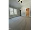 Bright bedroom showcases plush carpet, double windows, and convenient access to an ensuite bathroom at 6932 Buckhorn Duncan Rd, Holly Springs, NC 27540