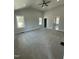 Spacious bedroom with neutral carpeting, a vaulted ceiling and natural light from two windows at 6932 Buckhorn Duncan Rd, Holly Springs, NC 27540