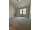 Welcoming bedroom filled with natural light, carpet, and an open entry to a bathroom at 6932 Buckhorn Duncan Rd, Holly Springs, NC 27540