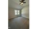 Comfortable bedroom with plush carpeting, neutral walls, and an abundance of natural light at 6932 Buckhorn Duncan Rd, Holly Springs, NC 27540