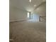 Expansive bonus room with plush carpet, neutral walls, and lots of natural light at 6932 Buckhorn Duncan Rd, Holly Springs, NC 27540