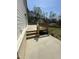 Side view of the wooden deck with concrete patio, offering a great outdoor living space at 6932 Buckhorn Duncan Rd, Holly Springs, NC 27540