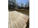 Large wooden deck perfect for outdoor entertaining and enjoying the beautiful surroundings at 6932 Buckhorn Duncan Rd, Holly Springs, NC 27540