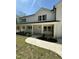 View of front porch with white columns, complementing the home's natural wood shutters and landscaping at 6932 Buckhorn Duncan Rd, Holly Springs, NC 27540
