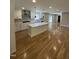 Modern kitchen with white cabinetry, stainless steel appliances, and a large center island at 6932 Buckhorn Duncan Rd, Holly Springs, NC 27540