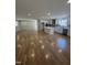 Modern kitchen with white cabinets, a center island, stainless steel appliances, and hardwood floors at 6932 Buckhorn Duncan Rd, Holly Springs, NC 27540