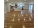 Open-concept living room and kitchen showcasing hardwood floors, recessed lighting, and a center island at 6932 Buckhorn Duncan Rd, Holly Springs, NC 27540