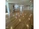 Spacious living room with hardwood floors, an open layout, a barn door, and ample natural light at 6932 Buckhorn Duncan Rd, Holly Springs, NC 27540
