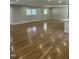 Bright living room with hardwood floors, neutral paint, and an open layout with kitchen views at 6932 Buckhorn Duncan Rd, Holly Springs, NC 27540