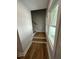 Stairway with hardwood treads and white risers, complemented by a large window providing natural light at 6932 Buckhorn Duncan Rd, Holly Springs, NC 27540