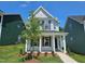 Charming two-story home featuring a covered porch and a well-manicured front yard at 728 Georgias Landing Pkwy # 9, Raleigh, NC 27603