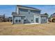 View of the backyard and exterior of the home featuring blue siding and a concrete patio at 75 Eltham, Rocky Mount, NC 27804