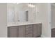 Neutral bathroom featuring a double sink vanity with grey cabinets and a large mirror at 75 Eltham, Rocky Mount, NC 27804