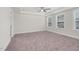 This bedroom features neutral carpet, a ceiling fan, and two windows that provide natural light at 75 Eltham, Rocky Mount, NC 27804