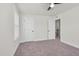 Carpeted bedroom with ceiling fan, neutral walls, window, and closet door at 75 Eltham, Rocky Mount, NC 27804