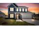 Charming two-story home with blue siding, brick accents, and a yellow front door under a beautiful sunset sky at 75 Eltham, Rocky Mount, NC 27804