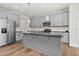 Close-up of kitchen with gray cabinets, black countertops, stainless steel appliances, and hardwood floors at 75 Eltham, Rocky Mount, NC 27804